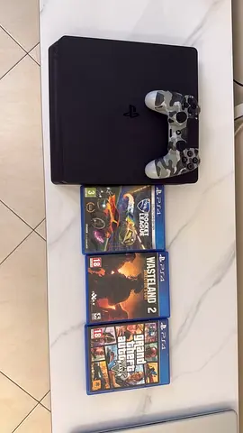 PlayStation 4 Slim with DualShock and 4 Games - Good Working Condition