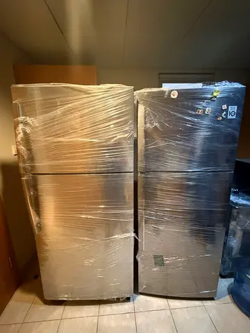 Two stainless steel refrigerators - good working condition, wrapped for transport