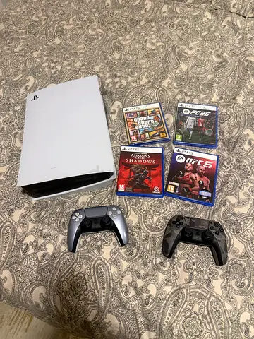 PlayStation 5 console with 2 DualSense controllers and 4 games