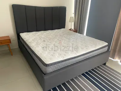 Grey upholstered queen bed frame with mattress (good condition)