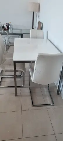 Modern white dining table with chrome legs and 4 chairs