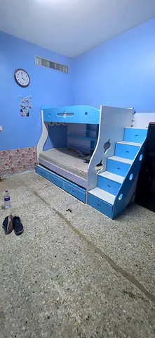 Blue wooden bunk bed with storage and desk - good condition