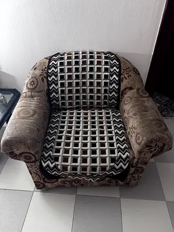Single upholstered armchair with patterned fabric — good condition