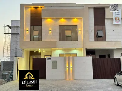Villa for sale in Ajman, Al Helio area. Includes registration fees, electricity, and air conditioning. 5 master bedrooms, majlis, living room, and mai
