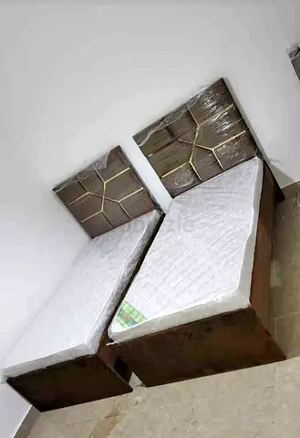 Pair of single wooden beds with mattresses - new