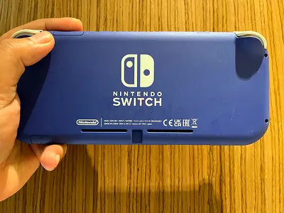 Nintendo Switch Lite (Blue) handheld console - amazing condition. Comes with pre installed games.