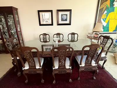 Solid wood carved 8-seater dining table with glass top