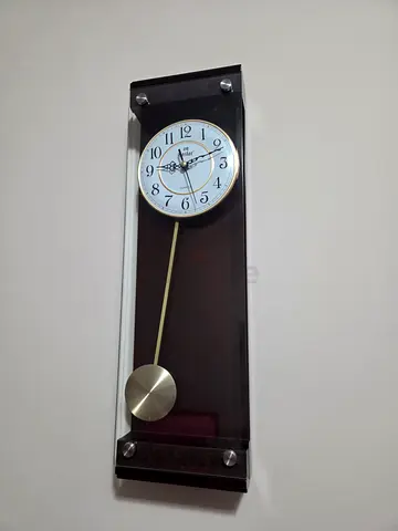 Wooden wall clock with pendulum