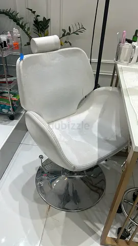 White swivel salon/barber chair with chrome base — good condition