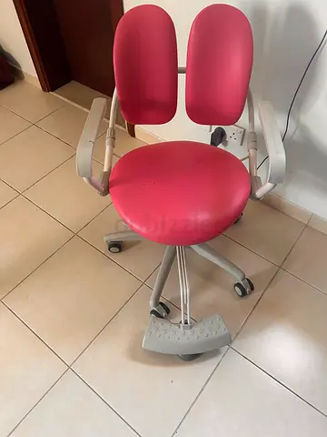 Ergonomic pink adjustable kids study chair with lumbar support.