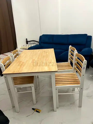 Wooden dining table with 4 matching chairs - light wood finish. Made in Malaysia. Homebox
