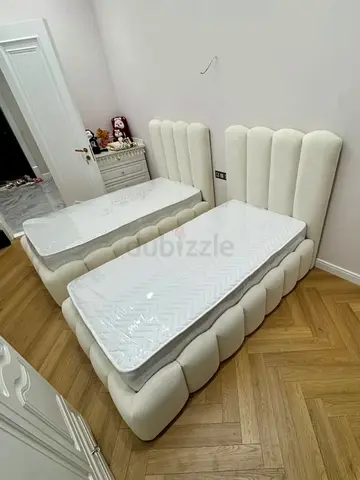 Pair of twin upholstered beds with scalloped headboards (set of 2)