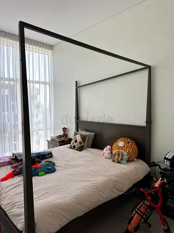 Metal four-poster double bed frame in good condition