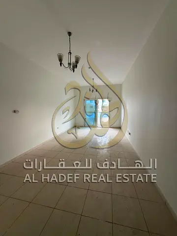 Two-bedroom apartment with a living room in Al Majaz 3 area. The apartment features a separate living room with a hallway and three bathrooms. Excelle