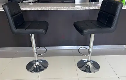 Pair of adjustable black leather bar stools with backrest