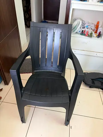 Used dark grey plastic patio/stackable chair - sturdy, good condition