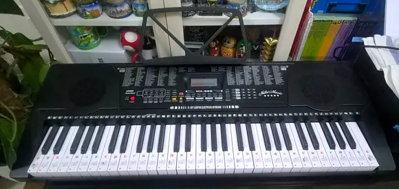 61-key electronic keyboard with standable base - used