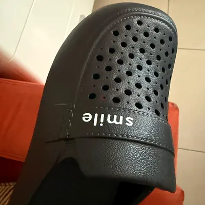 Black unisex slip-on clogs with perforated upper — lightly used