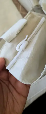 Pair of beige fabric curtains with sheer - used.