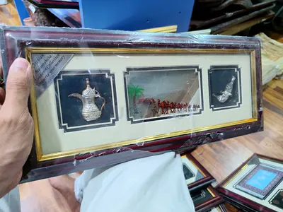 Framed Middle Eastern Decorative Plaque with Dallah, Camel Scene seven sand and Dagger 38*16cm
