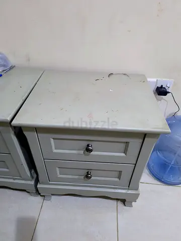 Pair of used beige wooden bedside cabinets with drawers
