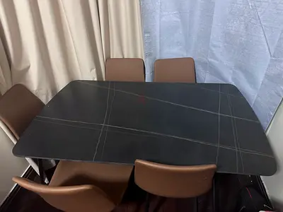 Modern black dining table with 6 brown chairs