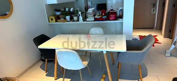 Ikea-style modern dining table with 5 mixed chairs
