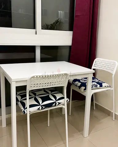 White Dining Set with Two Chairs and Patterned Cushions
