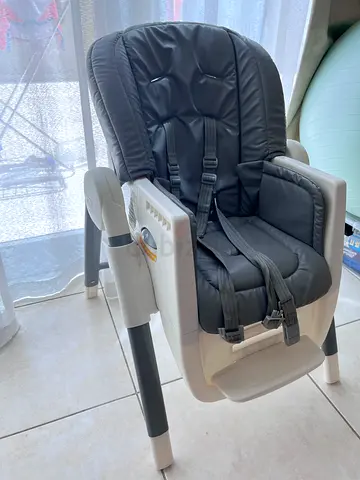 Used adjustable baby high chair with cushioned seat and safety harness