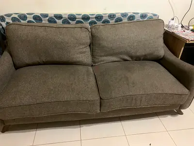 Two-seater grey fabric sofa in good condition