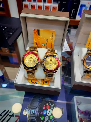 Pair of gold-tone mens wristwatches with red/black bezels (matching set)