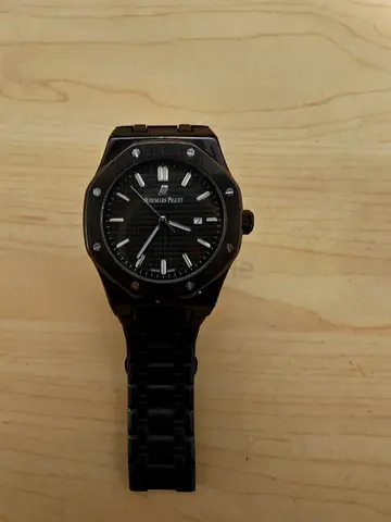 Black mens wristwatch with metal bracelet, used