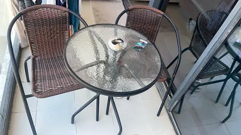 Outdoor bistro set - round glass table with two rattan chairs