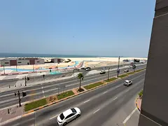 Three-bedroom apartment with a living room and direct sea view on Ajman Corniche