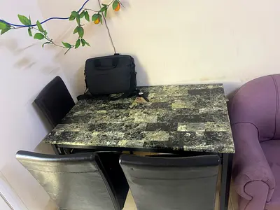 Compact marble-effect dining table with 3 black faux leather chairs - good condition