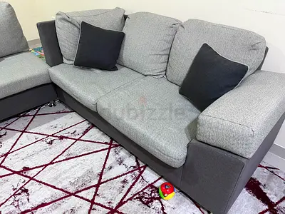 Grey L-shaped Fabric Sofa with Cushions - Good Condition