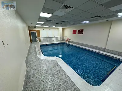 Two bedrooms and a living room with a balcony and free gym access with a kitchen in the Al Nuaimiya