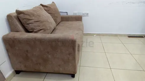 2-seater brown fabric sofa in good used condition