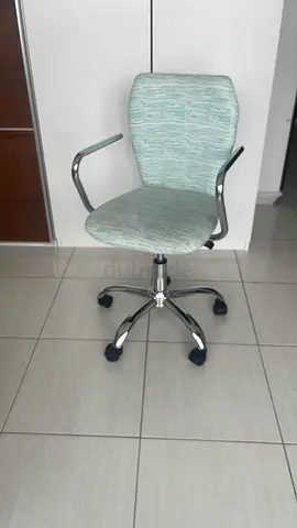 Light green swivel office chair with armrests — good condition