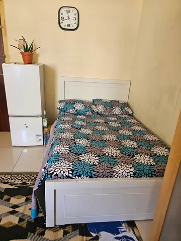 Single bed frame with mattress and bedding -