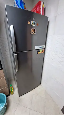 Used stainless steel double-door refrigerator with top freezer - good condition