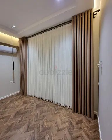 Pair of floor-to-ceiling beige blackout curtains with sheer inner panels -