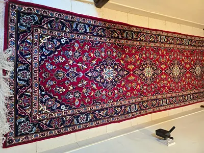 Long Persian-style runner rug in red — good condition
