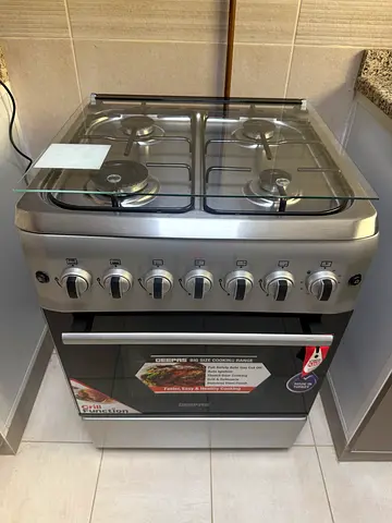 Used stainless steel 4-burner gas stove with oven - good condition
