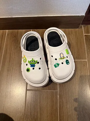 White slip-on clogs with cartoon charms