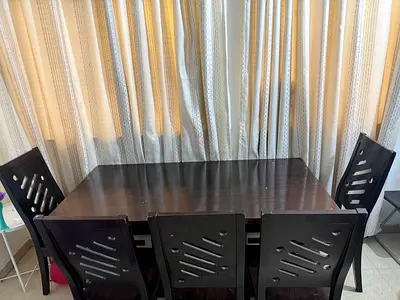 Dark wood 6-seater dining table with matching chairs