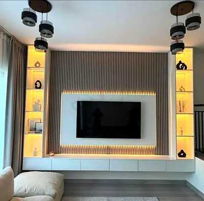 Modern built-in TV entertainment wall unit with illuminated display shelves