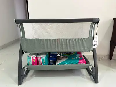 Lightweight grey bedside bassinet with storage shelf - like new