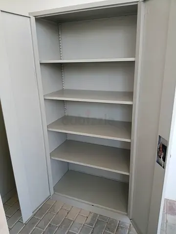 Tall metal storage cabinet with multiple internal shelves — good condition