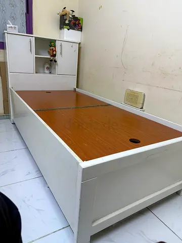 White wooden single bed frame with storage and headboard cabinet